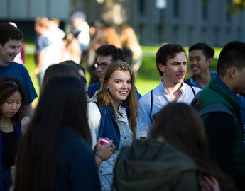 Student in a crowd, looking at camera